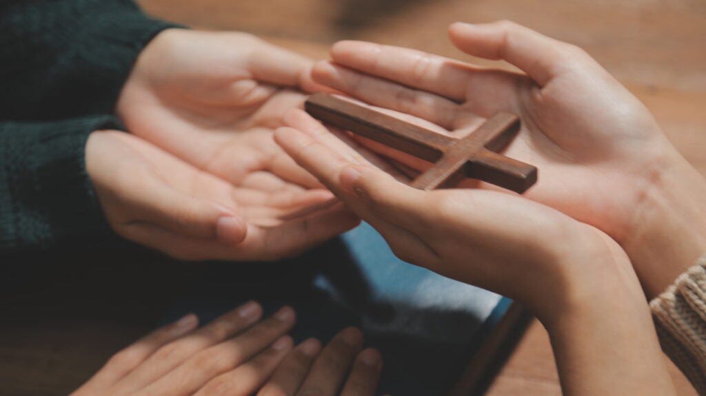 Christian group are praying to god with the bible and sharing th